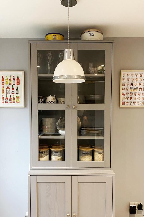 Elegant cabinet display showcases organized pantry, inspired by Ikea pantry ideas.