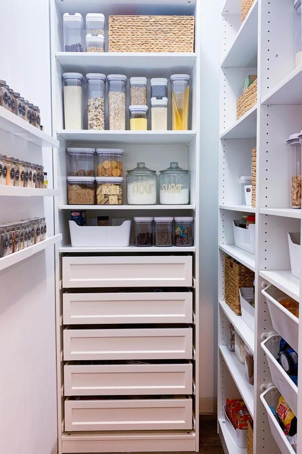 Alt text 13: Efficient pantry storage with customizable Ikea shelves and drawer systems.