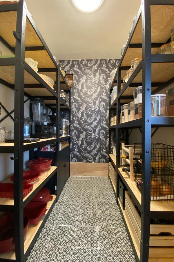 Bold wallpaper accent elevates pantry space using IKEA pantry ideas.