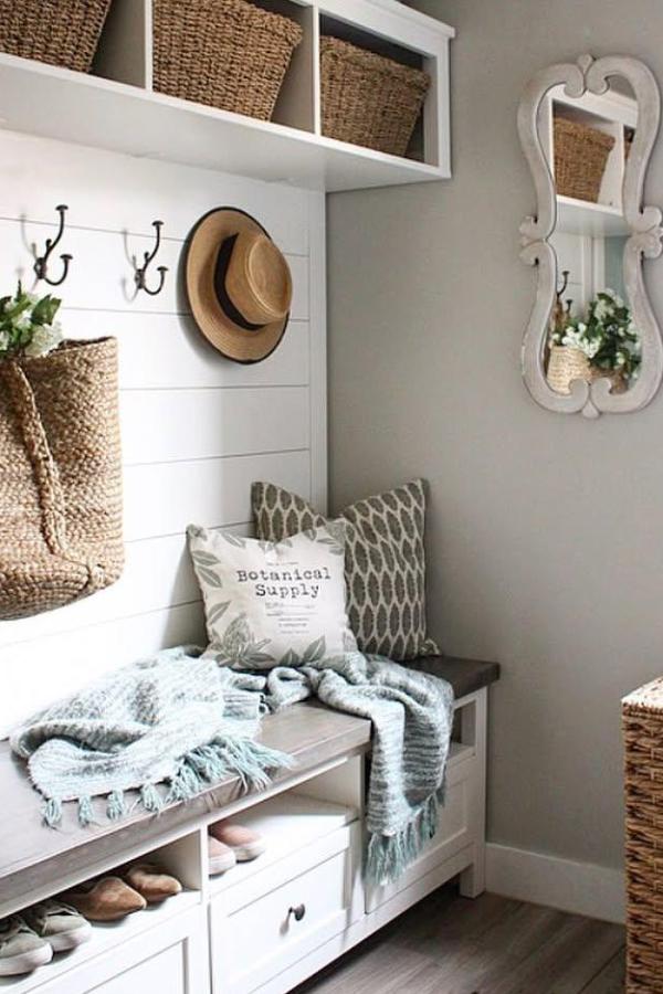 Farmhouse storage bench from @bloomingdiyer. White wooden bench with baskets and cozy pillows.