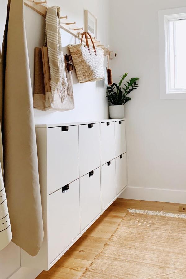 White wall-mounted shoe storage from @mysimplysimple showcasing practical ikea mud room ideas with natural decor accents.