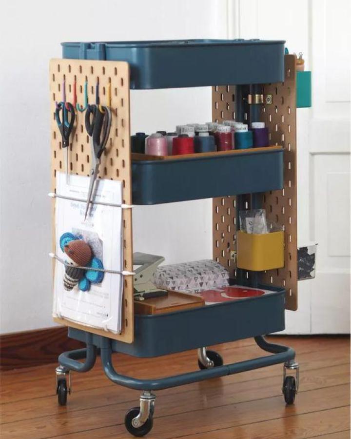 Teal mobile craft cart with attached birch pegboards showcasing creative ikea skadis pegboard hacks & ideas from @verena_weisnaehschen.