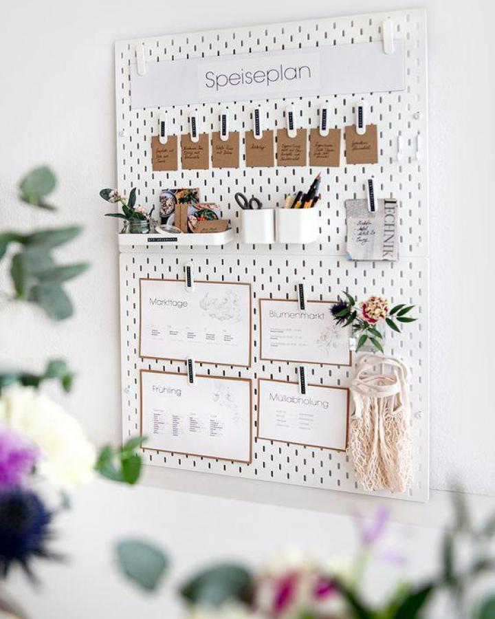 White pegboard meal planning station from Sammy Demmy featuring kraft paper labels and organizational containers.