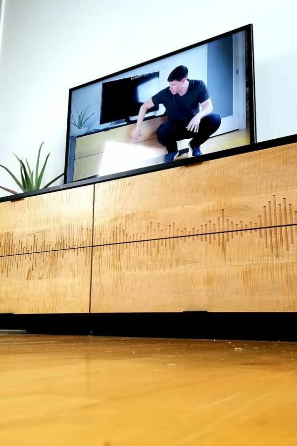 Light wood media console showcasing creative ikea dresser hacks & ideas from @modustrialmaker. Features carved sound wave pattern design.