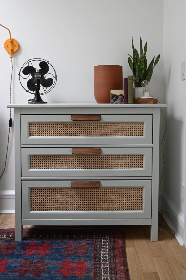 Sage green dresser with cane webbing drawer fronts from @brownstoneboys. Features leather pulls and vintage styling.