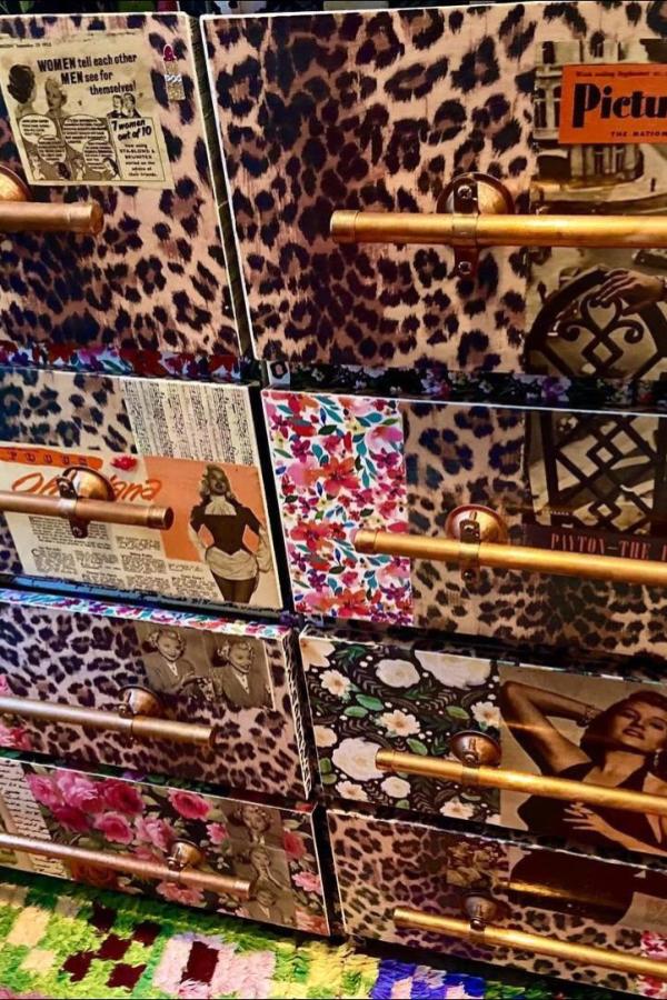 Leopard print dresser drawers from @lola.decor with vintage magazine collages and brass handles.