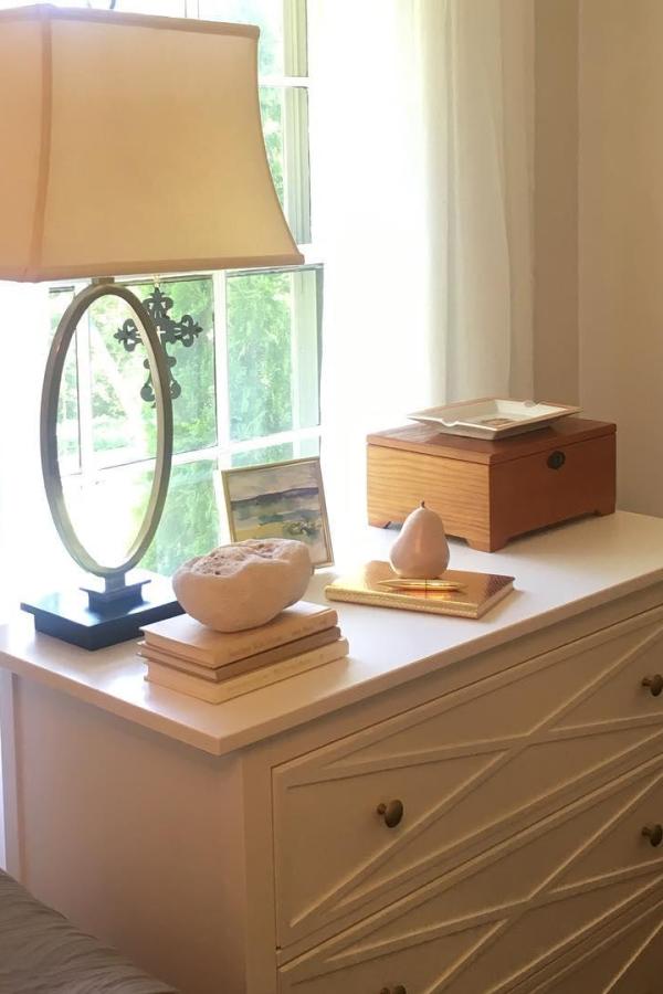 White dresser with geometric wood strip pattern from @cami.perry. Natural wood trim creates diamond design on drawer fronts.
