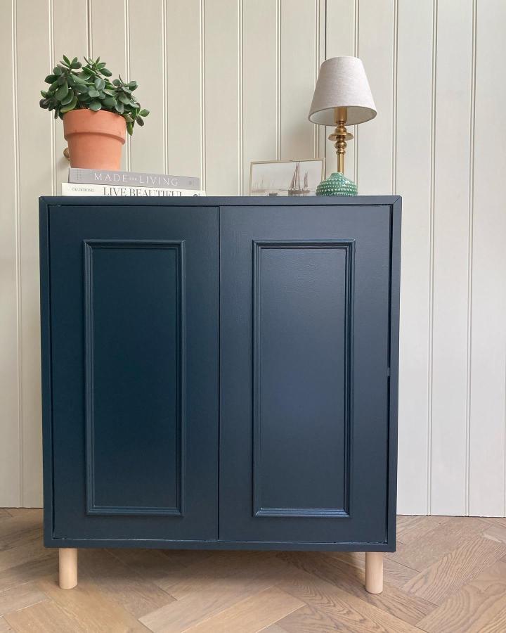 Navy blue cabinet storage unit from @1894home featuring ikea eket hacks & ideas with raised panel doors and wooden legs