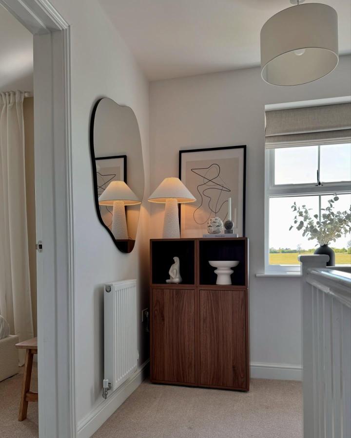 Walnut-wrapped Eket storage unit from @the_welham displaying ceramics with black interior backing treatment.