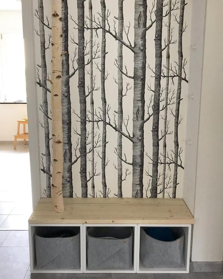 Forest-themed entryway bench featuring ikea eket hacks & ideas with gray storage baskets from @what_anette_loves. Natural wood top adds warmth.