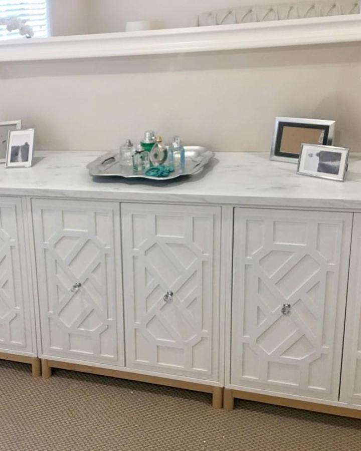 White geometric cabinet transformation from @myoverlays featuring intricate lattice door patterns.