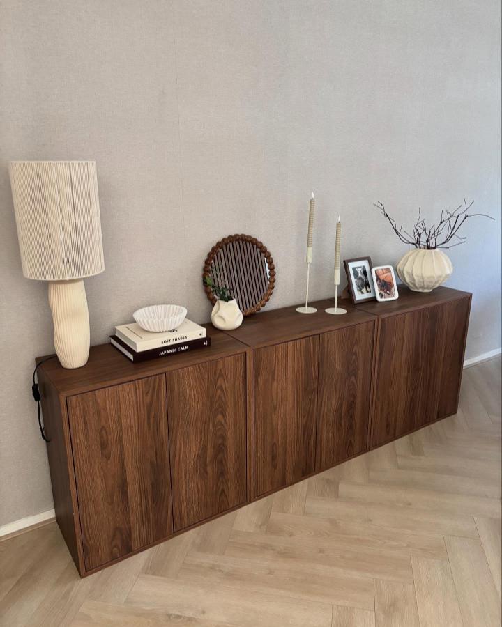 Rich walnut-finished floating credenza displaying decor pieces, showcasing creative ikea eket hacks & ideas from @homebylisan for modern living spaces.