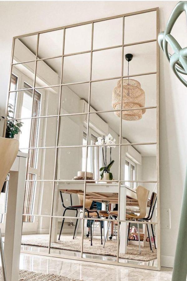 Large grid mirror wall installation from @chroniclesoflivi. Multiple square mirrors create dramatic room divider effect.