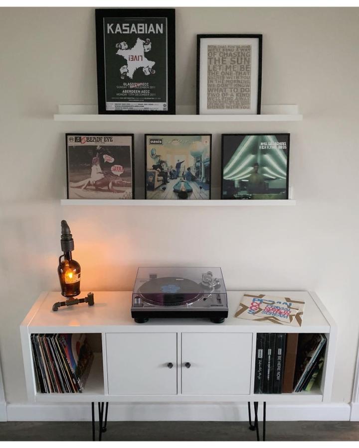 Modern vinyl display setup from @carldavey1 featuring white picture ledges and record storage unit.
