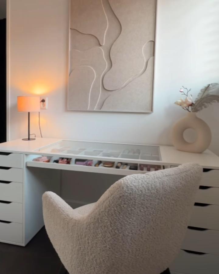 Minimalist white vanity setup from @7021instyle featuring clean glass surface and organized makeup storage drawers.