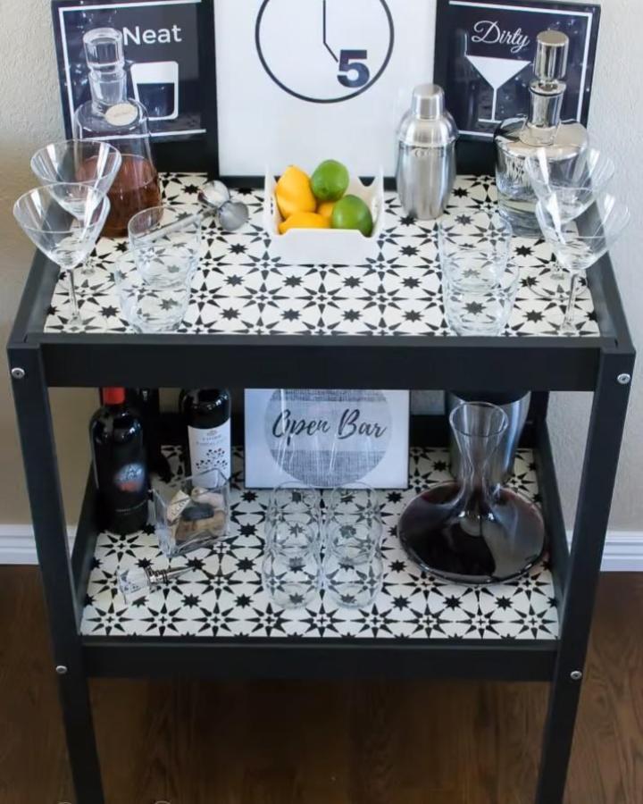Black and white geometric tiled bar cart from Garrison Street Design Studio featuring ikea bar cart hacks & ideas with cocktail accessories