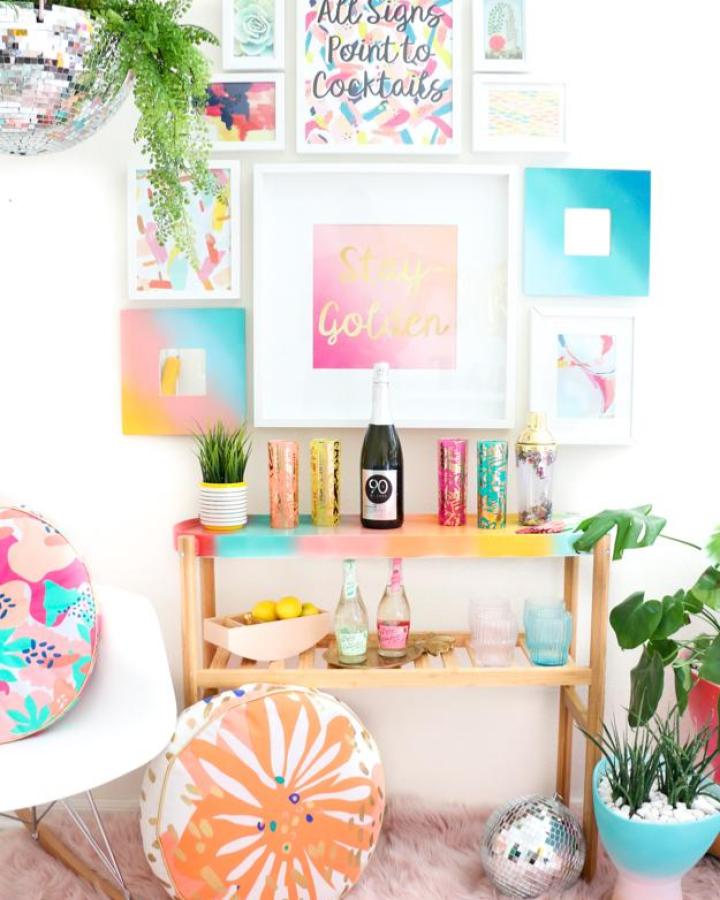 Rainbow gradient Satsumas plant stand from A Kailo Chic Life displaying beverages and colorful decor.