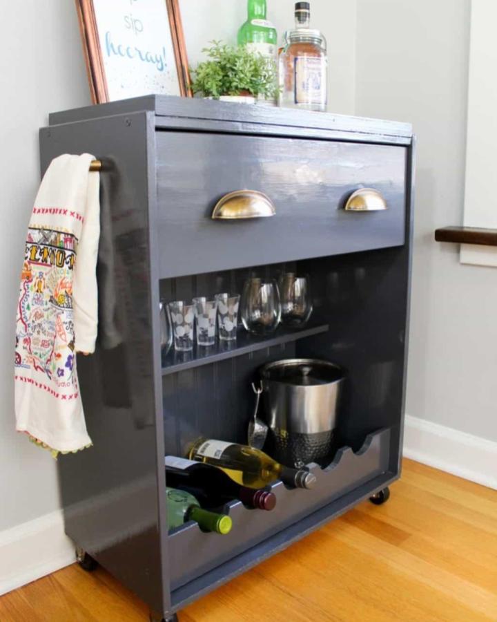 Charcoal gray Rast dresser bar cart from Average Inspired with brass cup pulls and casters