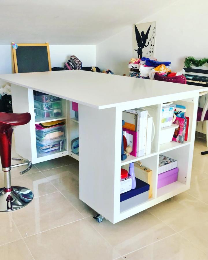 White Kallax cube desk from @alazros with colorful craft supplies and rolling casters