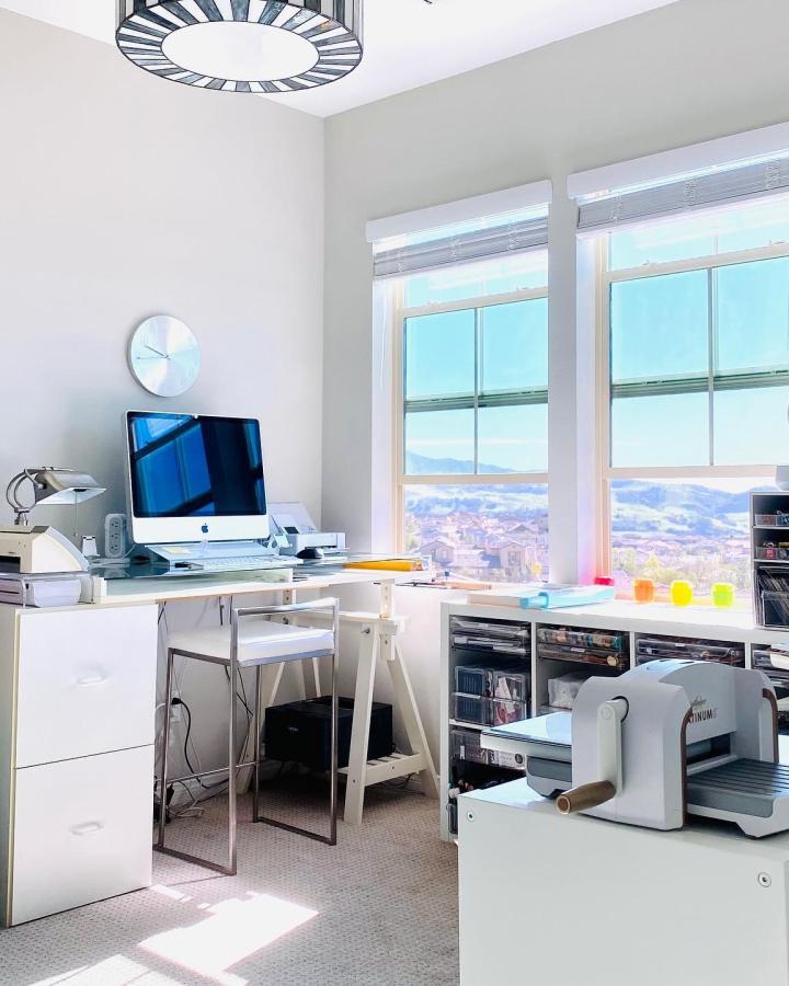 White Kallax storage unit from @lisasoares. Positioned under craft room windows with colorful tape rolls on sill.