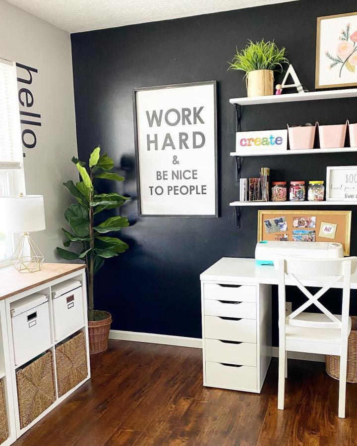 Navy-walled craft space from @bookgirlcreations showcasing ikea craft room ideas with white storage and floating shelves.
