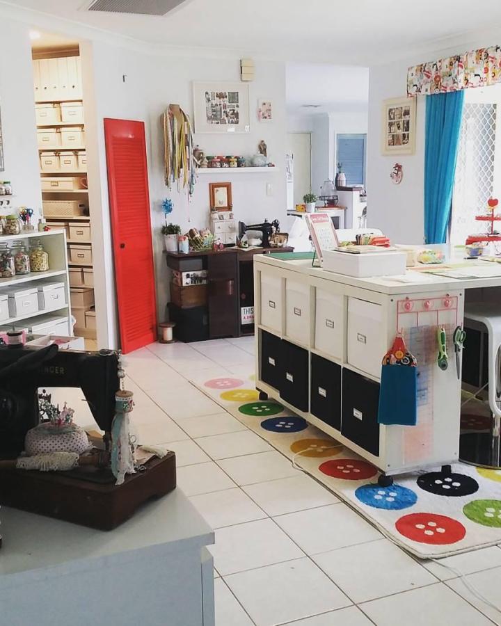 Bright red closet door and button floor mats from @teezsewcrafty with organized white storage units.