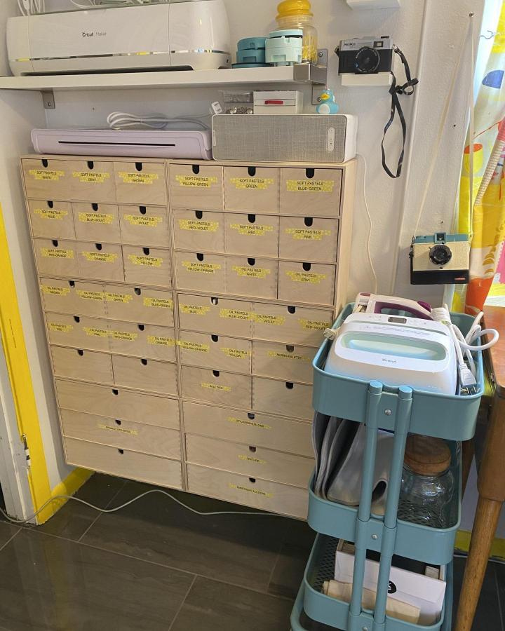 Natural wood labeled drawer system for ikea craft room ideas from @genna_riggins with yellow tags and Cricut storage.