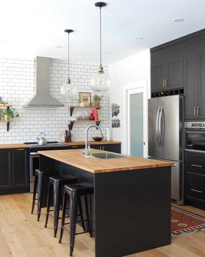 Charcoal island with butcher block countertop from @elyse.mccurdy_homedesigns showcasing ikea kitchen island ideas with breakfast bar seating.
