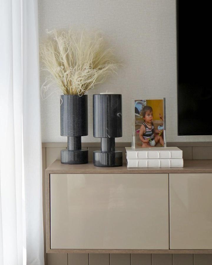 Beige cabinet styled for ikea media center hacks & ideas from @arteccustomwood. Sculptural vases and books on top.