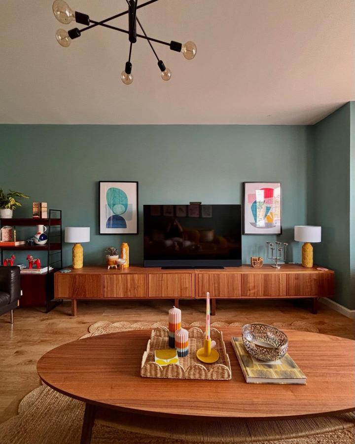 Walnut IKEA Stockholm media bench from @fromcity2suburb showcasing ikea media center hacks & ideas with sage walls and retro styling.