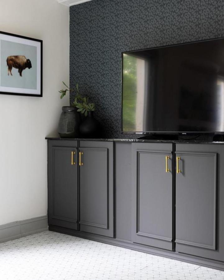 Charcoal Ivar media cabinets from @georgestownonmymind. Brass hardware complements dark floral wallpaper backdrop.