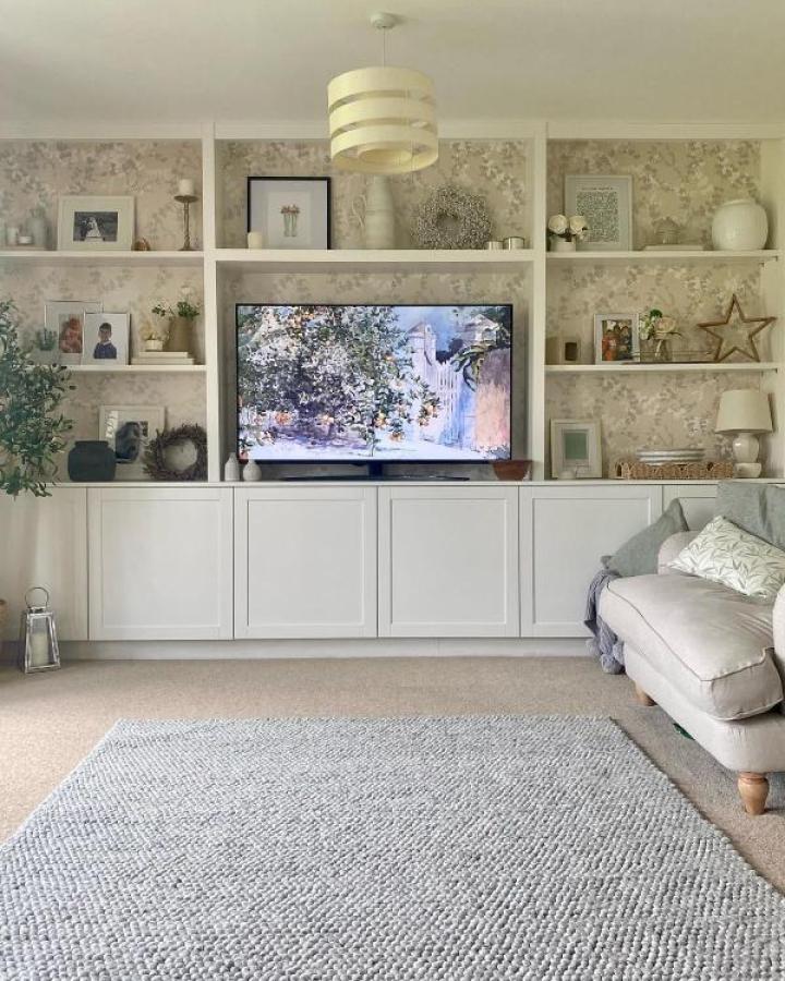 White Besta media center with floral wallpaper backing from @townhouse_on_the_green featuring open shelving display.