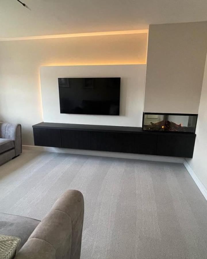 Black floating Besta media wall from @harrison.storyhomes. Recessed LED lighting with fireplace insert.