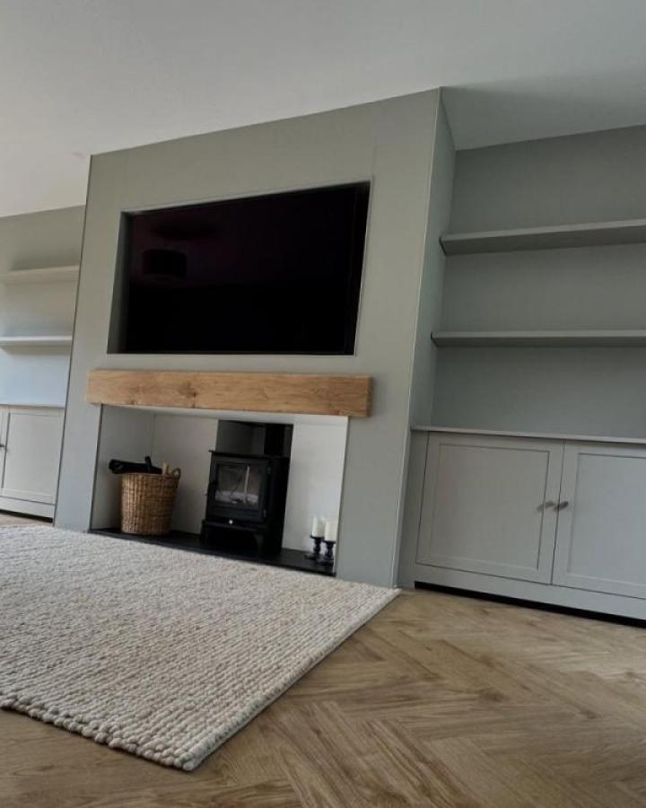 Sage-green built-in media center from @suffolkdoorsandwindows featuring ikea media center hacks & ideas with fireplace alcove