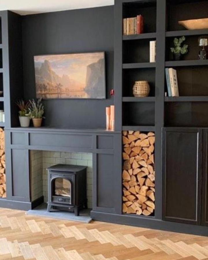 Charcoal Billy bookcase fireplace wall from @fixupjaynesharp. Built-in shelving with wood stove and storage.
