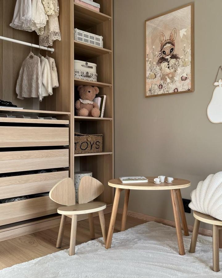 Beige Pax wardrobe system from @eikhaugen_. Open shelving with hanging clothes and natural wood drawers.