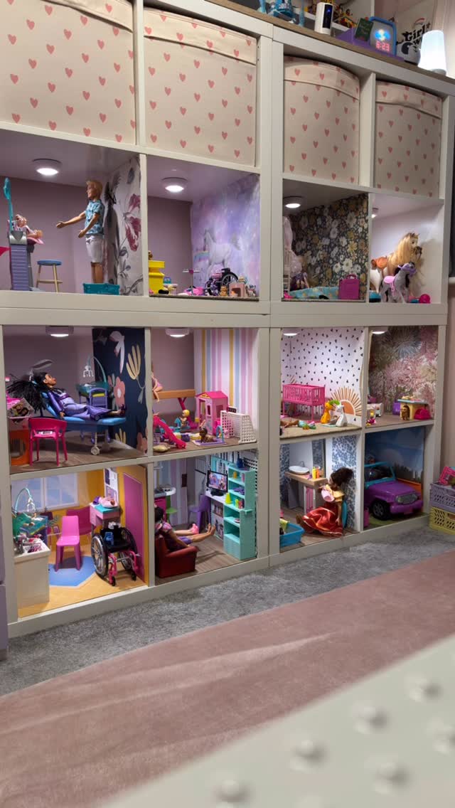 White Kallax cube unit from @thehumphreysdreams transformed into multi-level Barbie dollhouse with decorated rooms.