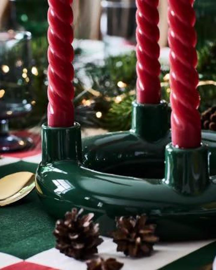 Dark green ceramic candle holder from Ikea, part of ikea 2025 christmas collection must haves with twisted red candles.