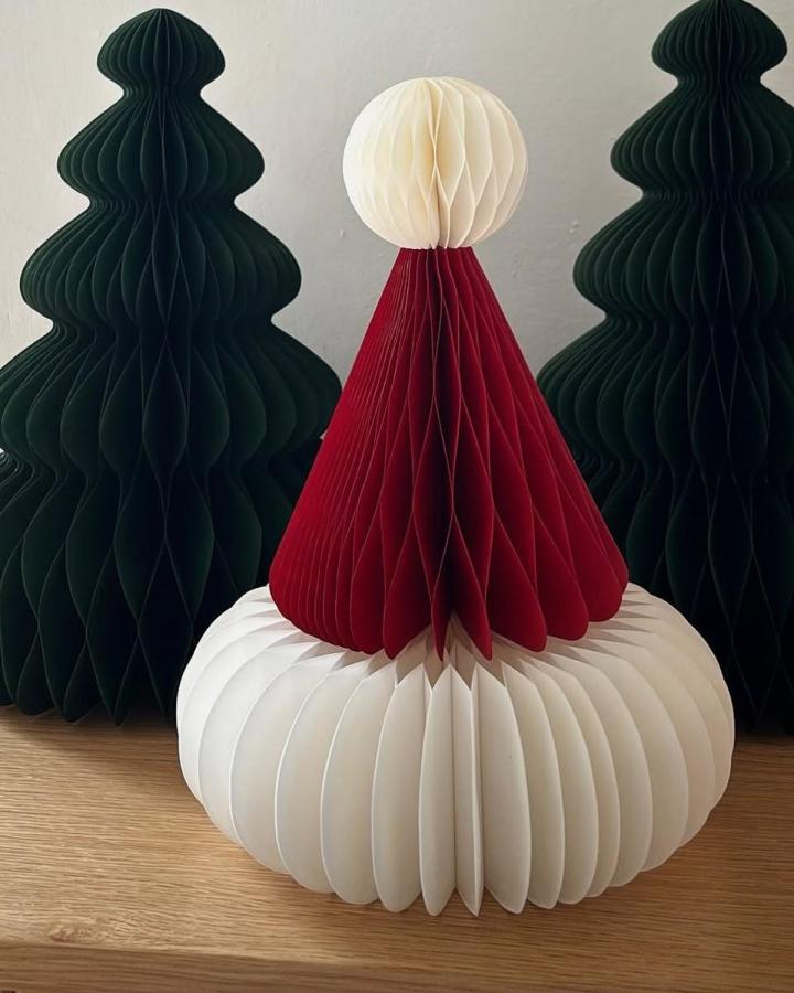 Cream and red honeycomb paper sculpture from @vanessakardelke with stacked Vinterfint decorations creating playful character design