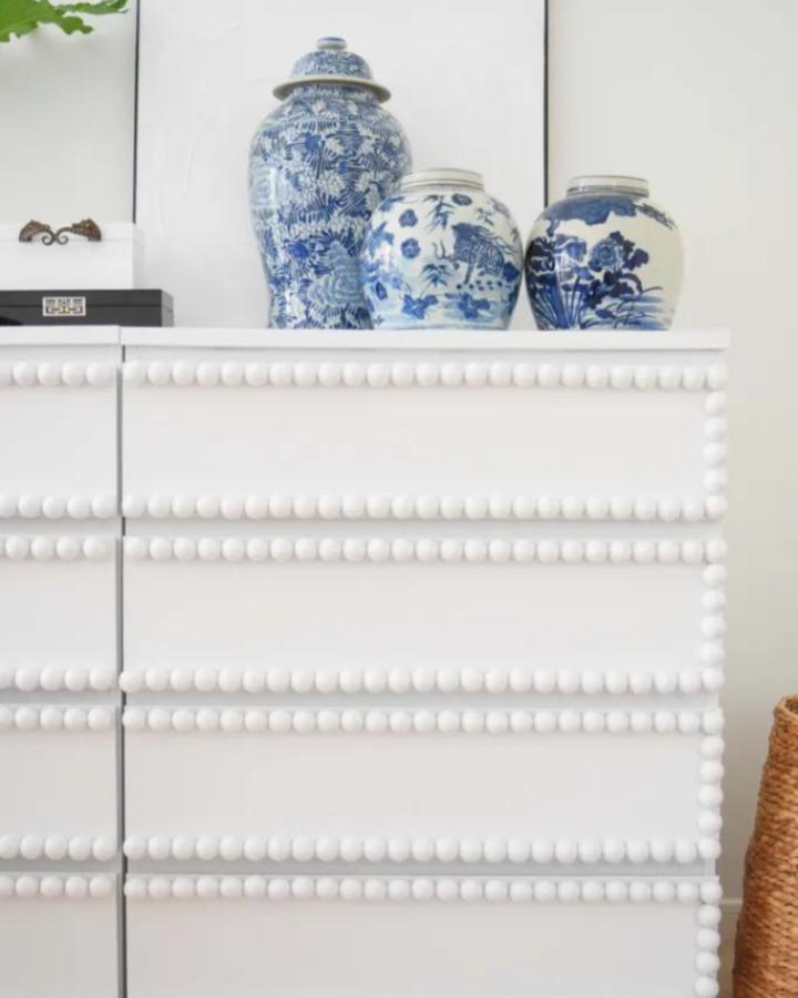 White bobbin-trimmed Malm dresser from My Dear Irene. Blue ginger jars displayed on top.