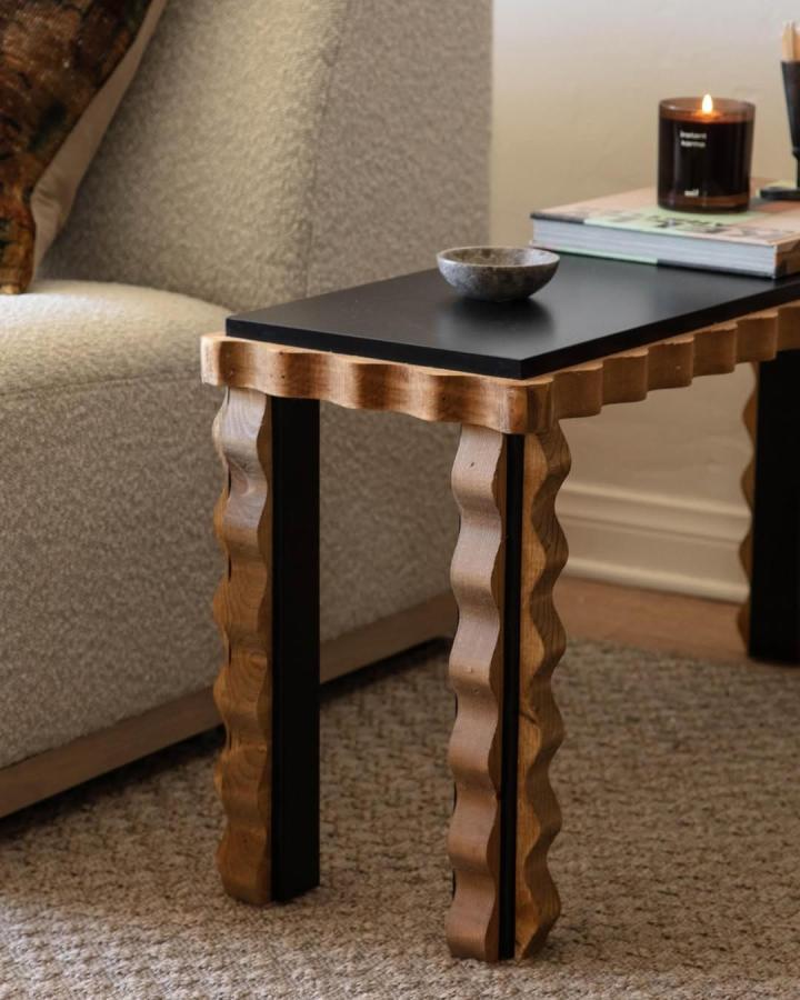 Black-topped side table with scalloped natural wood legs from @lonefoxhome. Sculptural Ikea Lack transformation.