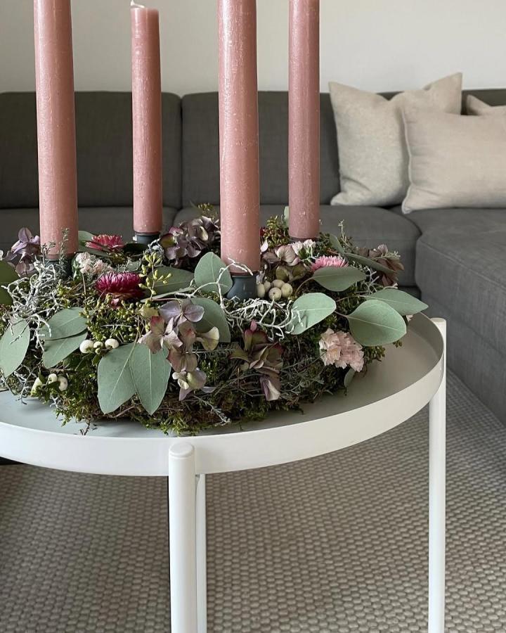 Moss and eucalyptus advent wreath on white Gladom table from @_laura_living with dusty pink candles.