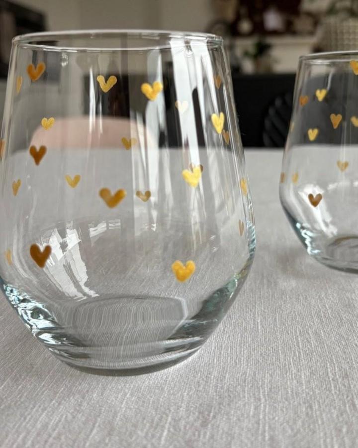 Gold heart painted clear glassware from @_laura_living. Simple festive table accent with hand-painted details.