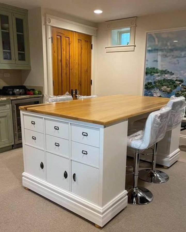 White craft island from UltimateCraftDesk with butcher block top and metal drawer pulls.