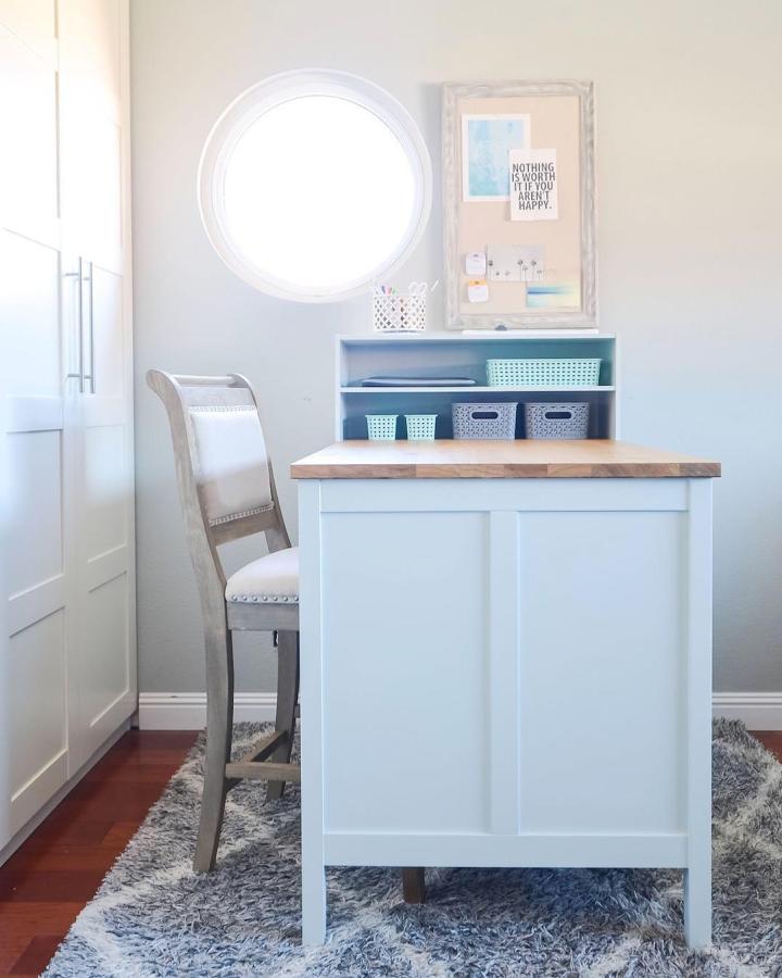 White Tornviken island with teal shelving showcasing ikea craft table hacks & ideas from @katy_ashadeofteal with organized storage baskets