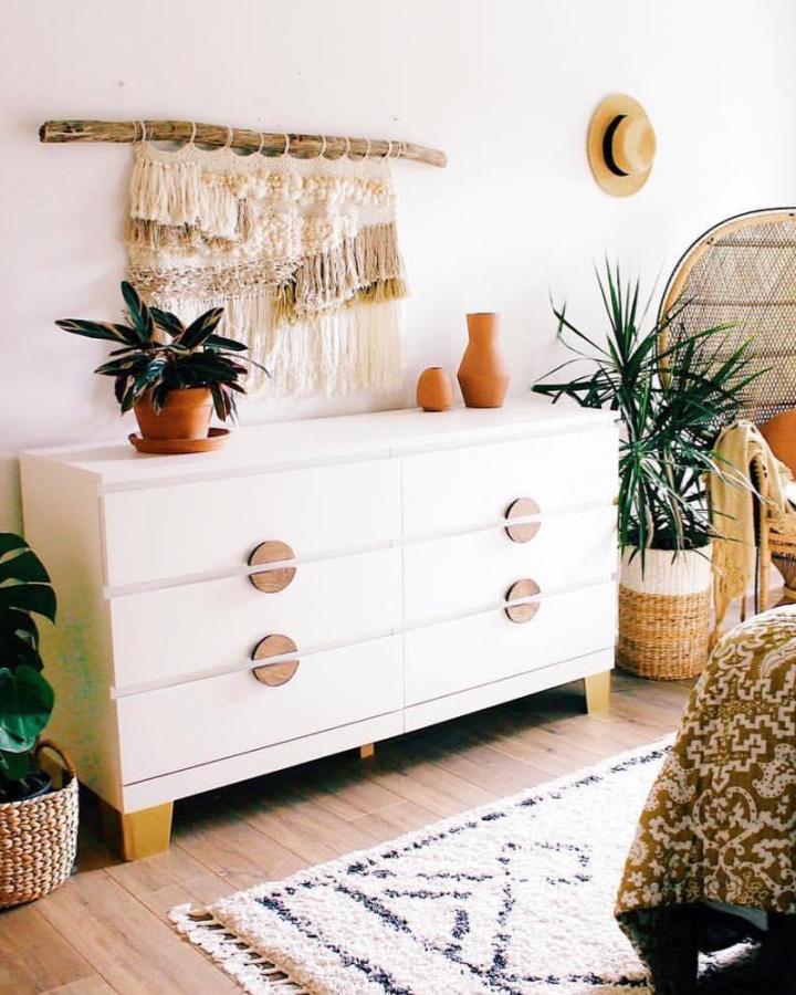white modern dresser with natural wood knobs and legs in cozy boho bedroom setting ikea malm hacks & ideas from @prettypegs