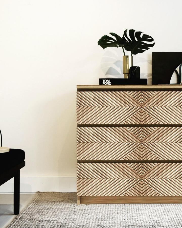 light wood carved dresser with geometric patterns in stylish bedroom from @mikeadeluxe. ikeam malm hacks & ideas for textured storage redesign