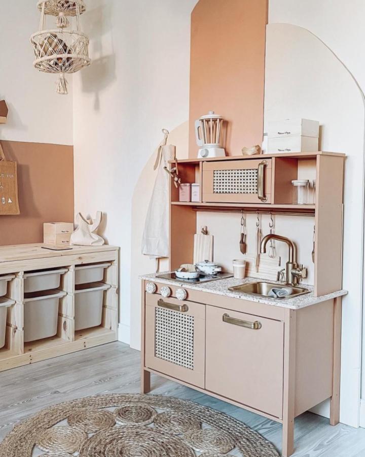 Neutral Ikea Duktig play kitchen from @stilrausch_sandra. Cane inserts and terracotta wall accent.