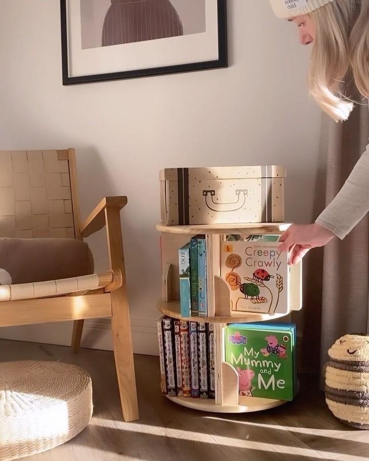 Natural birch rotating bookshelf from @project_34_selfbuild. Stacked lazy susans hold children's books at accessible height.
