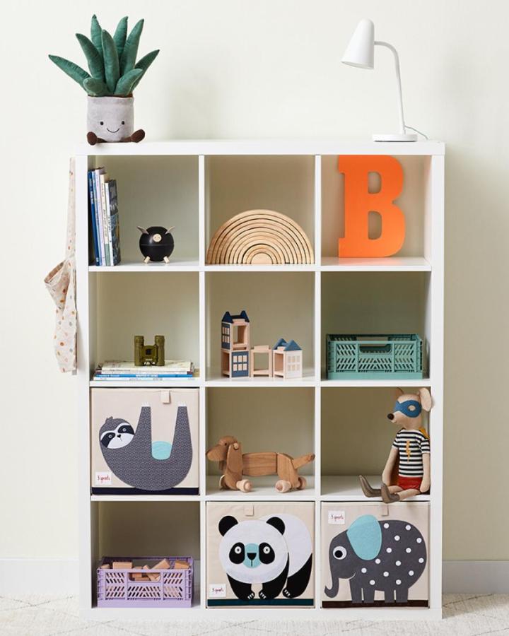 White cube shelving displaying ikea playroom storage hacks & ideas from @3_sprouts with animal storage bins and wooden toys